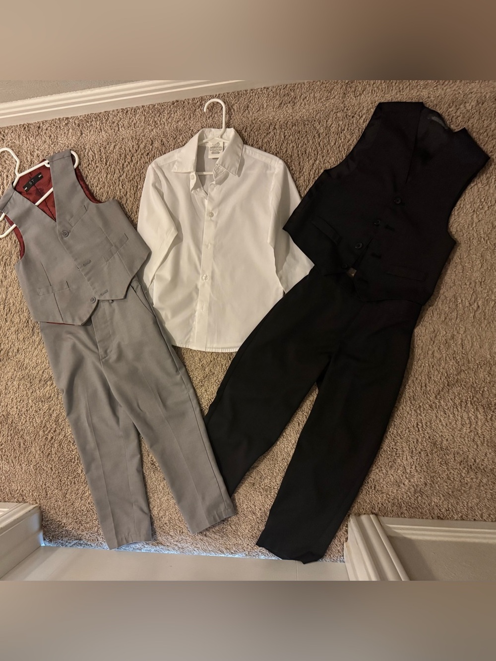 Two pairs of slacks with matching vests, and one white dress shirt
